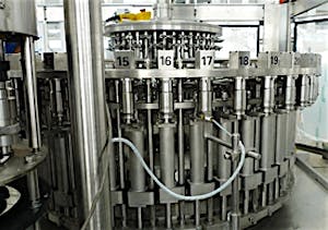Photo of a stainless-steel rotary bottle filling machine